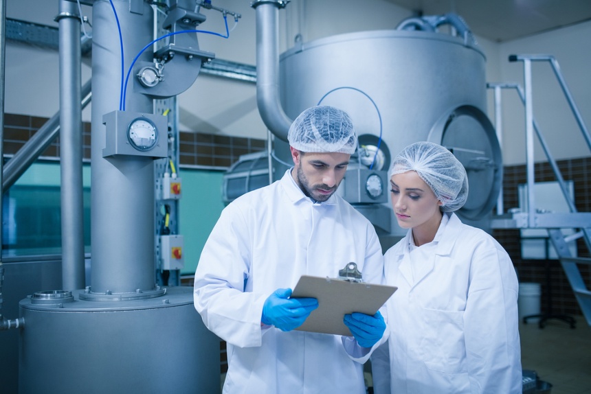 Food technicians working together in a food processing plant